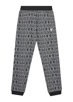 Guess Spodnie dresowe J5YQ13 KAD74 Szary Regular Fit ze sklepu MODIVO w kategorii Spodnie chłopięce - zdjęcie 183885574