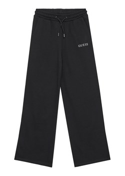 Guess Spodnie dresowe J5YQ14 KA6R4 Czarny Regular Fit ze sklepu MODIVO w kategorii Spodnie dziewczęce - zdjęcie 183932143
