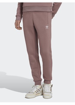 adidas Spodnie dresowe adicolor Essentials Trefoil HK0105 Różowy Slim Fit ze sklepu MODIVO w kategorii Spodnie damskie - zdjęcie 183945474