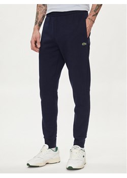 Lacoste Spodnie dresowe XH9624 Granatowy Regular Fit ze sklepu MODIVO w kategorii Spodnie męskie - zdjęcie 183946762