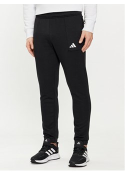 adidas Spodnie dresowe Pump Workout IT4310 Czarny Regular Fit ze sklepu MODIVO w kategorii Spodnie męskie - zdjęcie 183946952