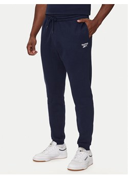 Reebok Spodnie dresowe HH8325 Granatowy Regular Fit ze sklepu MODIVO w kategorii Spodnie męskie - zdjęcie 183948294
