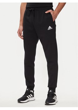adidas Spodnie dresowe Essentials Fleece Regular Tapered Joggers HL2236 Czarny Regular Fit ze sklepu MODIVO w kategorii Spodnie męskie - zdjęcie 183948442