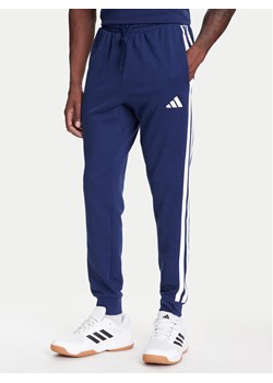 adidas Spodnie dresowe Essential 3-Stripes JD1878 Niebieski Regular Fit ze sklepu MODIVO w kategorii Spodnie męskie - zdjęcie 184019230