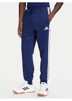 adidas Spodnie dresowe Essentials 3-Stripes JD1859 Niebieski Regular Fit ze sklepu MODIVO w kategorii Spodnie męskie - zdjęcie 184019321