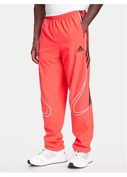 adidas Spodnie dresowe Teamgeist adicolor JW5871 Czerwony Loose Fit ze sklepu MODIVO w kategorii Spodnie męskie - zdjęcie 184045680