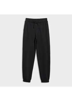 Dziewczęce spodnie dresowe joggery 4F 4FJWMM00TTROF1189 - czarne ze sklepu Sportstylestory.com w kategorii Spodnie dziewczęce - zdjęcie 184525881