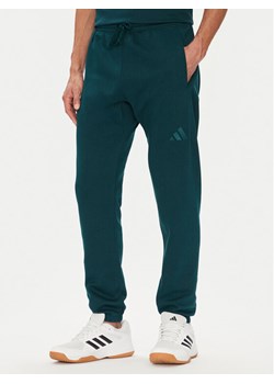 adidas Spodnie dresowe ALL SZN Fleece JX5096 Zielony Tapered Leg ze sklepu MODIVO w kategorii Spodnie męskie - zdjęcie 184632610