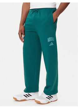 adidas Spodnie dresowe Collegiate JM9178 Zielony Regular Fit ze sklepu MODIVO w kategorii Spodnie męskie - zdjęcie 184661111
