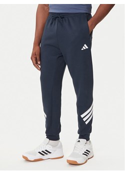 adidas Spodnie dresowe Future Icons 3-Stripes JW7088 Granatowy Regular Fit ze sklepu MODIVO w kategorii Spodnie męskie - zdjęcie 184672713