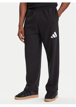 adidas Spodnie dresowe Essentials JF3567 Czarny Loose Fit ze sklepu MODIVO w kategorii Spodnie męskie - zdjęcie 184787730