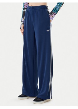 adidas Spodnie dresowe adicolor Firebird JV7524 Granatowy Regular Fit ze sklepu MODIVO w kategorii Spodnie damskie - zdjęcie 184920313