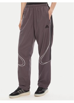 adidas Spodnie dresowe Teamgeist adicolor JW5870 Szary Loose Fit ze sklepu MODIVO w kategorii Spodnie męskie - zdjęcie 185391402