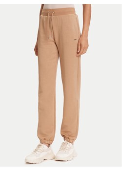 Guess Spodnie dresowe V5YB06 KBSL2 Beżowy Regular Fit ze sklepu MODIVO w kategorii Spodnie damskie - zdjęcie 185564374