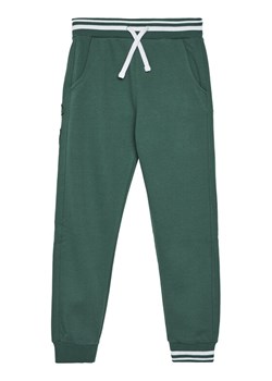 Guess Spodnie dresowe L5YQ17 K0170 Zielony Regular Fit ze sklepu MODIVO w kategorii Spodnie chłopięce - zdjęcie 185737474