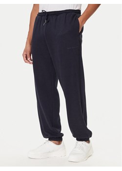 Tommy Hilfiger Spodnie dresowe UM0UM03627 Niebieski Regular Fit ze sklepu MODIVO w kategorii Spodnie męskie - zdjęcie 186030953