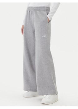 adidas Spodnie dresowe ALL SZN Holiday Glitter Fleece JV5758 Szary Loose Fit ze sklepu MODIVO w kategorii Spodnie damskie - zdjęcie 186151430
