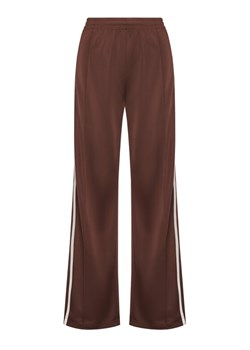 adidas Spodnie dresowe adicolor Firebird KD2526 Brązowy Loose Fit ze sklepu MODIVO w kategorii Spodnie damskie - zdjęcie 186338673