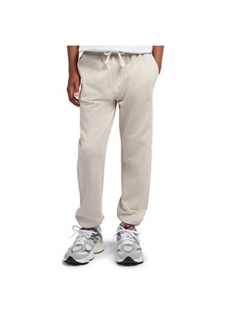 Spodnie dziecięce New Balance LAKB0060TWF - beżowe ze sklepu streetstyle24.pl w kategorii Spodnie chłopięce - zdjęcie 187282003