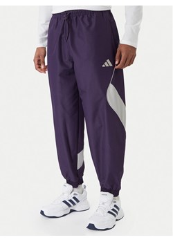 adidas Spodnie dresowe Stadium JX5610 Fioletowy Loose Fit ze sklepu MODIVO w kategorii Spodnie męskie - zdjęcie 187489200