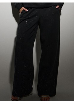 Sinsay - Dresowe spodnie z szeroką nogawką i brokatem - czarny ze sklepu Sinsay w kategorii Spodnie damskie - zdjęcie 187610032