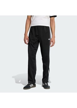 adidas Spodnie dresowe Firebird KD8315 Czarny Loose Fit ze sklepu MODIVO w kategorii Spodnie męskie - zdjęcie 187696251