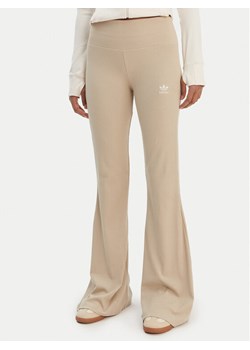 adidas Legginsy Essentials KD3850 Beżowy Flared Leg ze sklepu MODIVO w kategorii Spodnie damskie - zdjęcie 187803122