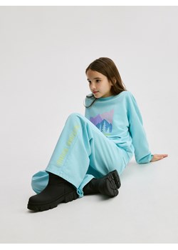 Reserved - Spodnie dresowe z nadrukiem - jasnoturkusowy ze sklepu Reserved w kategorii Spodnie dziewczęce - zdjęcie 187959062