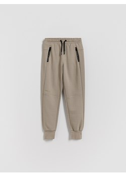 Reserved - Bawełniane spodnie jogger - beżowy ze sklepu Reserved w kategorii Spodnie chłopięce - zdjęcie 188090493