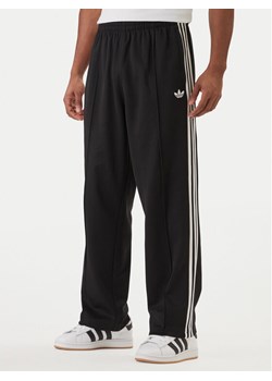 adidas Spodnie dresowe adicolor KE3501 Czarny Loose Fit ze sklepu MODIVO w kategorii Spodnie męskie - zdjęcie 188514791