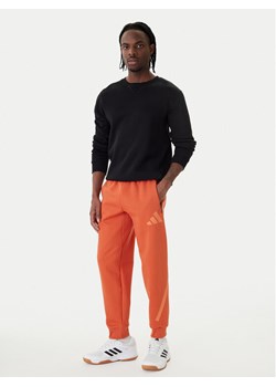 adidas Spodnie dresowe Z.N.E. KE4686 Pomarańczowy Regular Fit ze sklepu MODIVO w kategorii Spodnie męskie - zdjęcie 188748520