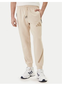adidas Spodnie dresowe Z.N.E. KE4684 Beżowy Regular Fit ze sklepu MODIVO w kategorii Spodnie męskie - zdjęcie 188913783