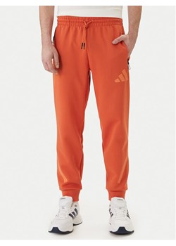 adidas Spodnie dresowe Z.N.E. KE4686 Pomarańczowy Regular Fit ze sklepu MODIVO w kategorii Spodnie męskie - zdjęcie 188913790