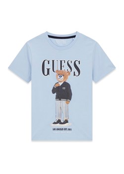 Guess T-Shirt L6GI09 K8HM4 Błękitny Regular Fit ze sklepu MODIVO w kategorii T-shirty chłopięce - zdjęcie 189135633