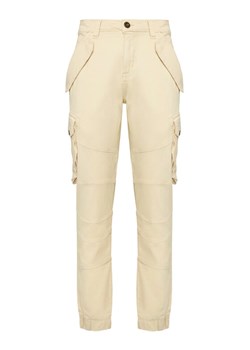 Alpha Industries Spodnie materiałowe Combat 126215 Écru Slim Fit ze sklepu MODIVO w kategorii Spodnie męskie - zdjęcie 189216882