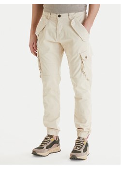 Alpha Industries Spodnie materiałowe Combat 126215 Écru Slim Fit ze sklepu MODIVO w kategorii Spodnie męskie - zdjęcie 189315332