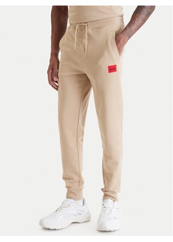 HUGO Spodnie dresowe Doak212 50447963 Beżowy Regular Fit ze sklepu MODIVO w kategorii Spodnie męskie - zdjęcie 189387312
